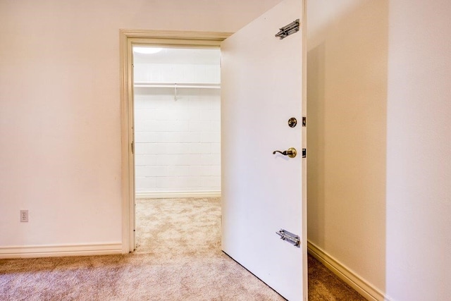 hallway with carpet and baseboards