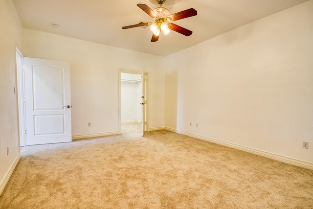 spare room with ceiling fan, carpet flooring, and baseboards