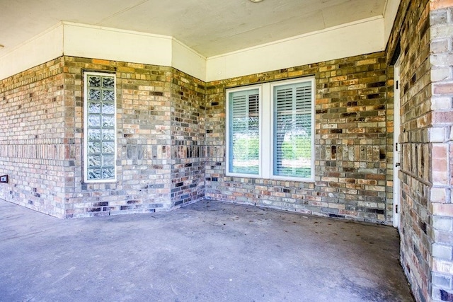 doorway to property featuring brick siding