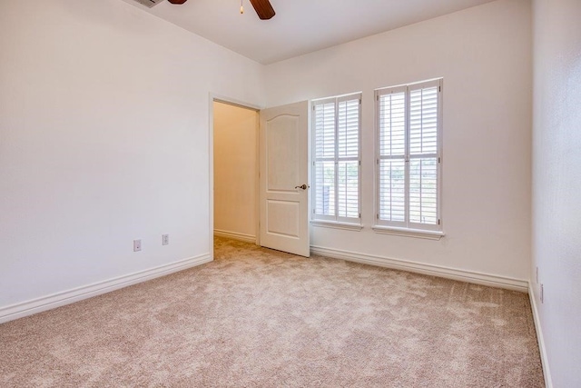 unfurnished room with ceiling fan, baseboards, and carpet flooring