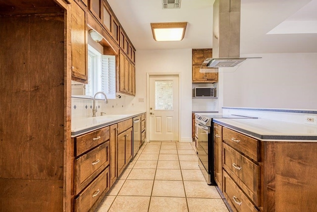 kitchen with visible vents, a sink, island exhaust hood, stainless steel appliances, and light tile patterned flooring