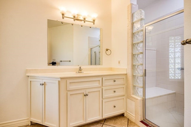 full bathroom with a shower stall, tile patterned floors, and vanity