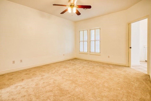 unfurnished room with ceiling fan, carpet, and baseboards