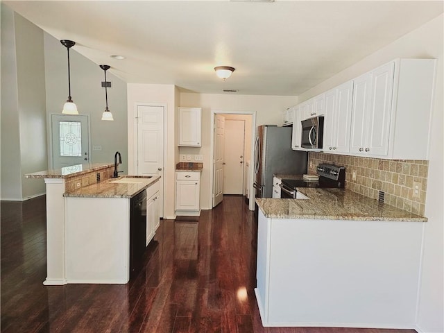 kitchen with appliances with stainless steel finishes, decorative light fixtures, sink, white cabinets, and light stone countertops