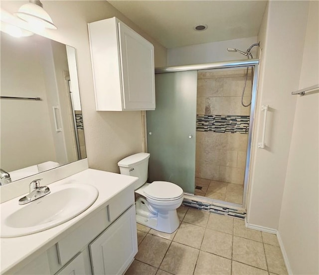 bathroom featuring an enclosed shower, vanity, tile patterned flooring, and toilet