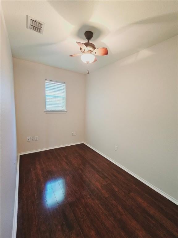 empty room with ceiling fan and dark hardwood / wood-style floors