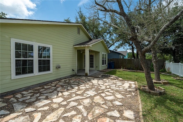 rear view of house featuring a patio and a lawn