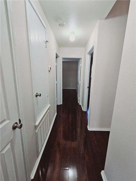 corridor featuring dark hardwood / wood-style floors