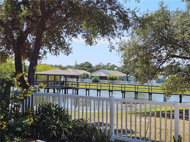 exterior space with a gazebo, a water view, and a yard