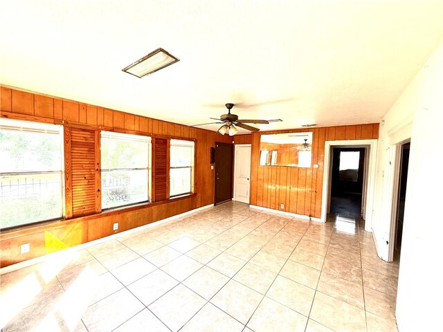 1609 15th St, Corpus Christi, TX 78404 - unfurnished room featuring wood walls, ceiling fan, and light tile patterned floors
