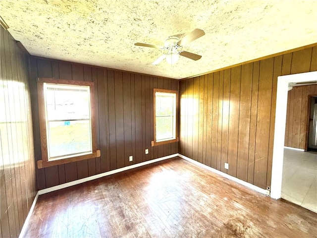 1609 15th St, Corpus Christi, TX 78404 - spare room with wood finished floors, a ceiling fan, and wood walls
