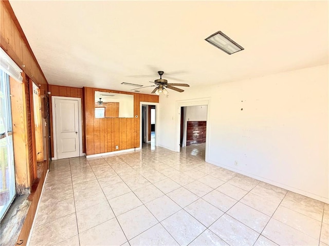 1609 15th St, Corpus Christi, TX 78404 - spare room featuring wood walls, ceiling fan, healthy amount of natural light, and light tile patterned flooring