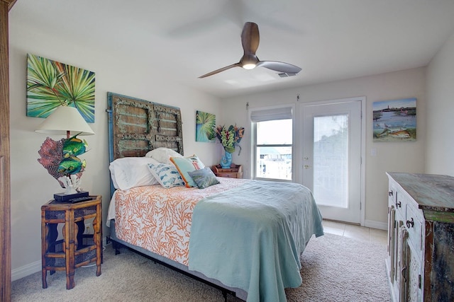 bedroom with light tile patterned flooring, ceiling fan, and access to exterior