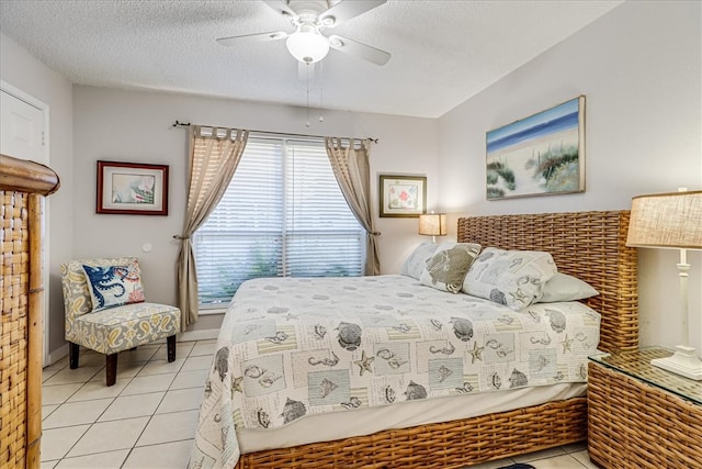 bedroom featuring a textured ceiling, ceiling fan, and light tile patterned flooring