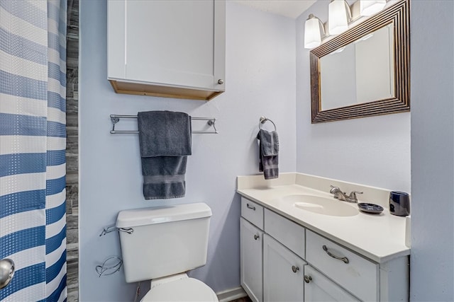 bathroom with toilet and vanity