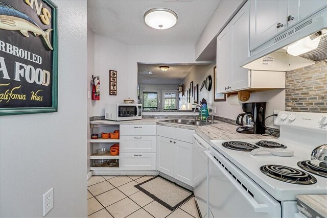 dining area featuring a textured ceiling and light tile patterned floors