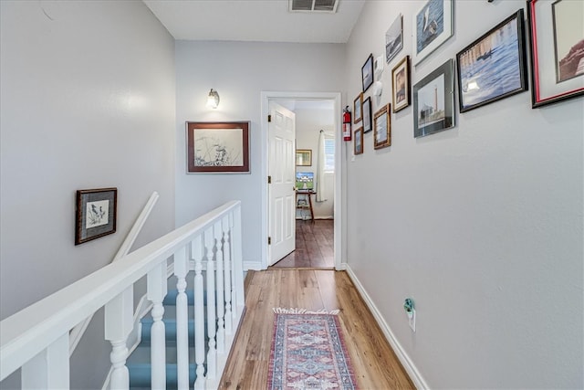 hallway with hardwood / wood-style floors