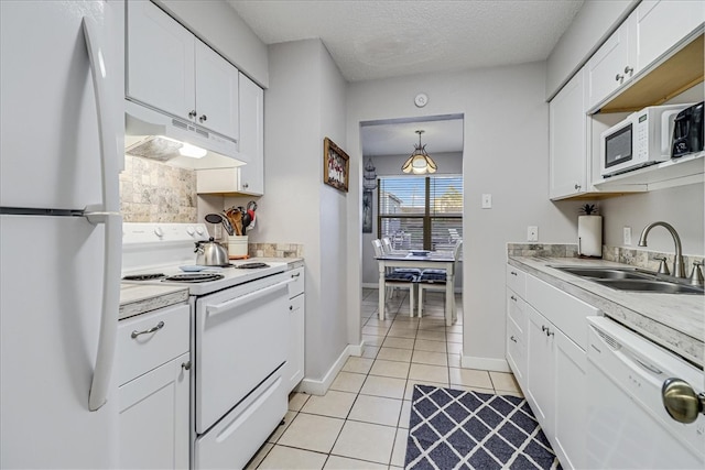 kitchen featuring light tile patterned flooring, sink, a textured ceiling, white appliances, and white cabinets