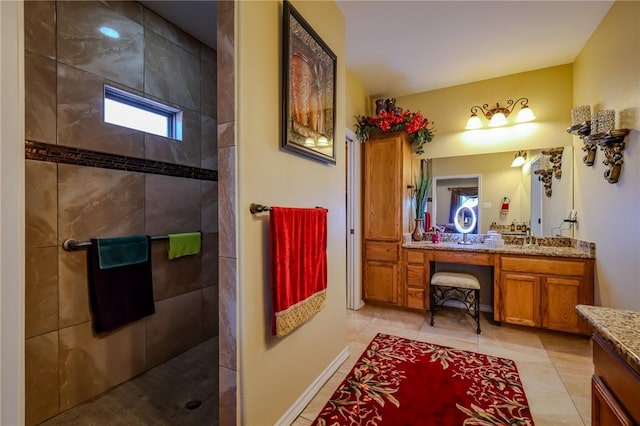 bathroom featuring tile patterned floors, vanity, and tiled shower