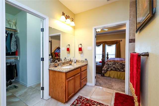 bathroom featuring ceiling fan, tile patterned floors, and vanity