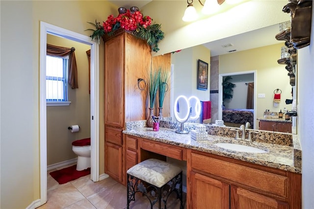 bathroom featuring toilet, tile patterned floors, and vanity