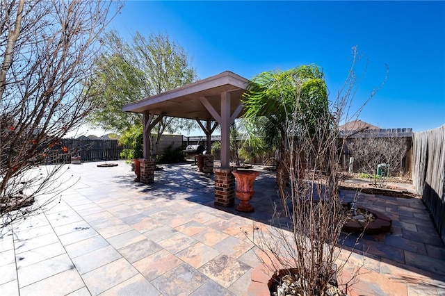 view of patio featuring a gazebo and exterior bar