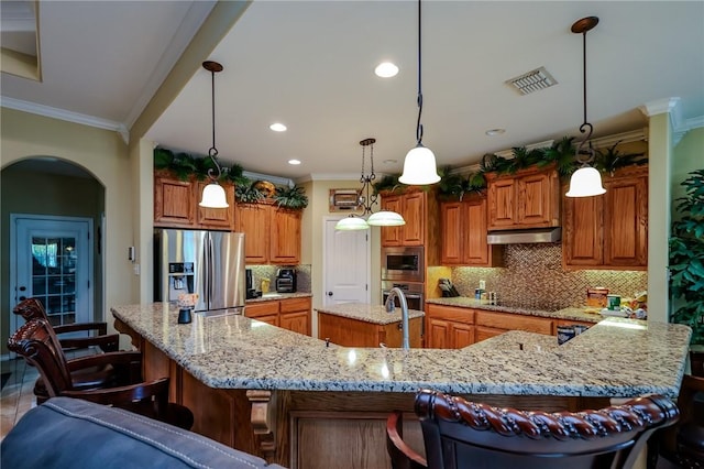 kitchen with backsplash, a spacious island, crown molding, hanging light fixtures, and stainless steel appliances