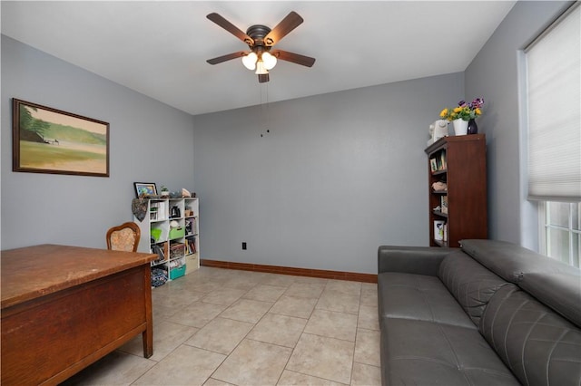 tiled home office featuring ceiling fan