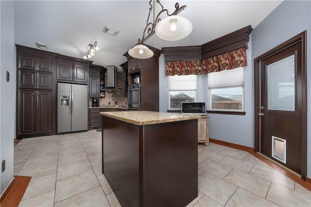 kitchen with stainless steel appliances, a center island, dark brown cabinetry, decorative backsplash, and wall chimney exhaust hood