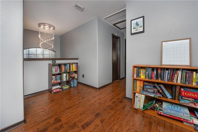 interior space featuring dark hardwood / wood-style floors and a notable chandelier