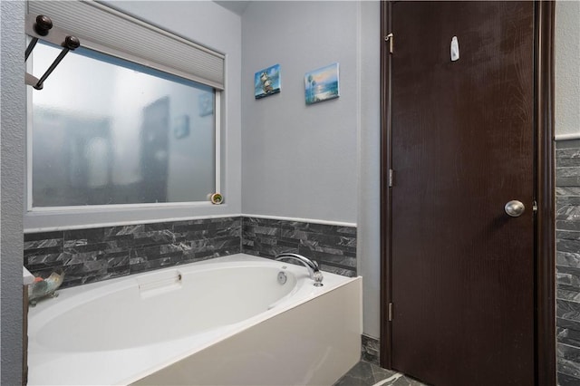 bathroom featuring a washtub