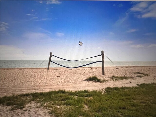 view of home's community with a beach view, volleyball court, and a water view