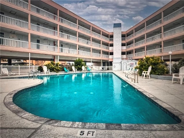 view of swimming pool with a patio