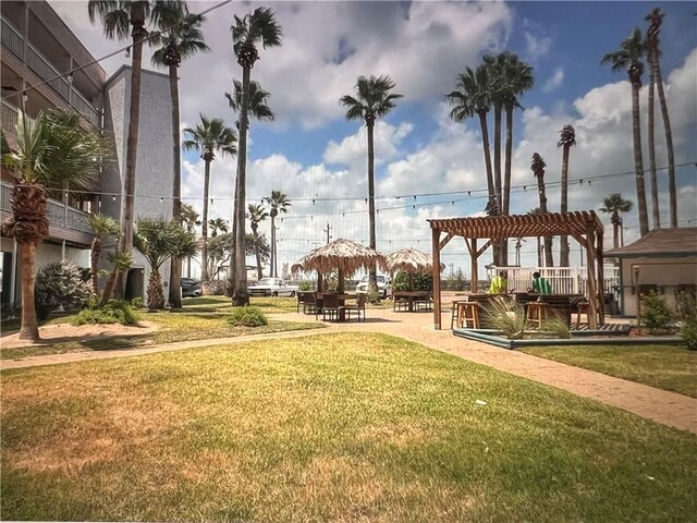 view of community with a yard and a pergola