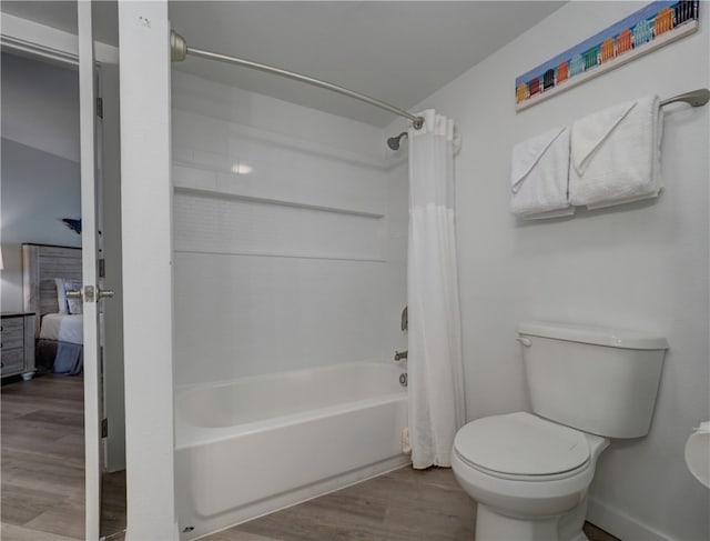 bathroom featuring shower / bath combo, wood-type flooring, and toilet