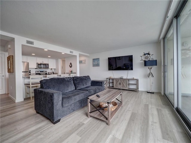 800 Sandcastle Dr Unit 513, Port Aransas, TX 78373 - living room with light wood-style flooring, baseboards, and recessed lighting