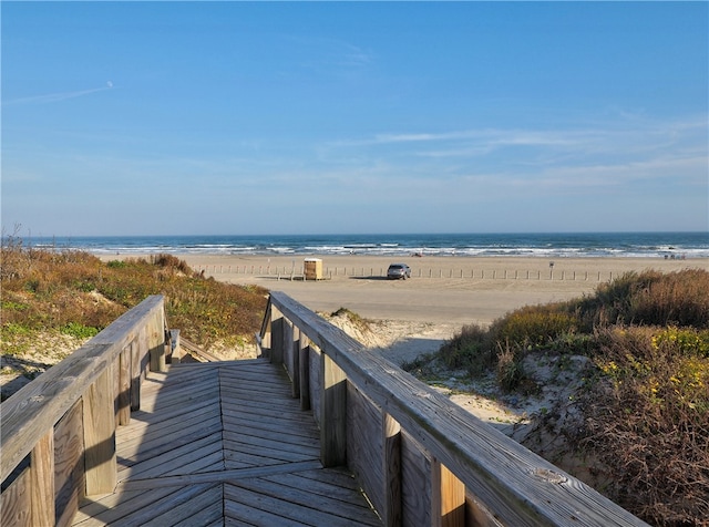 view of property's community with a beach view and a water view