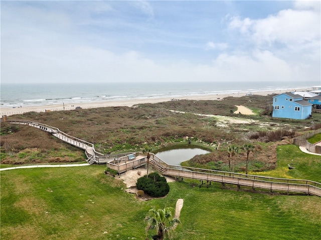 drone / aerial view featuring a beach view and a water view