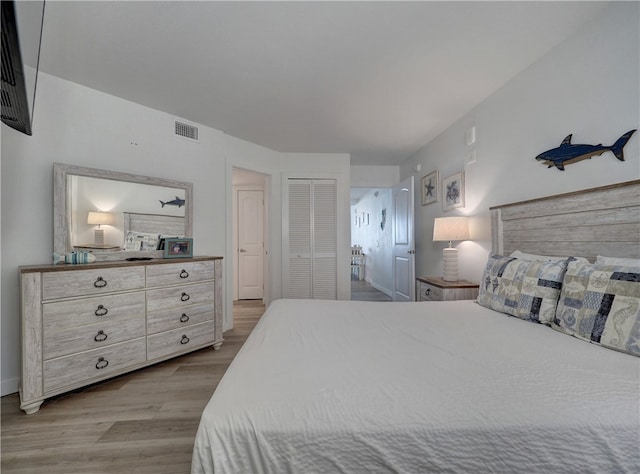 bedroom with a closet and light wood-type flooring