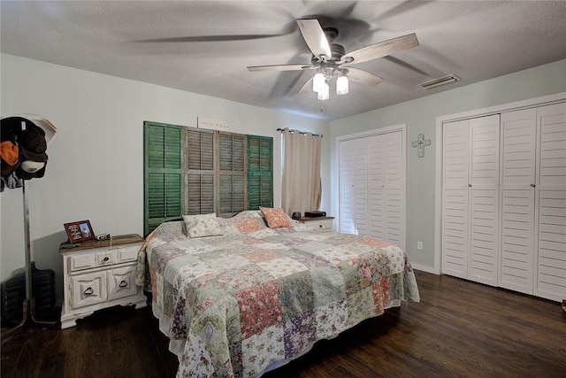 bedroom with ceiling fan, dark hardwood / wood-style floors, and a textured ceiling