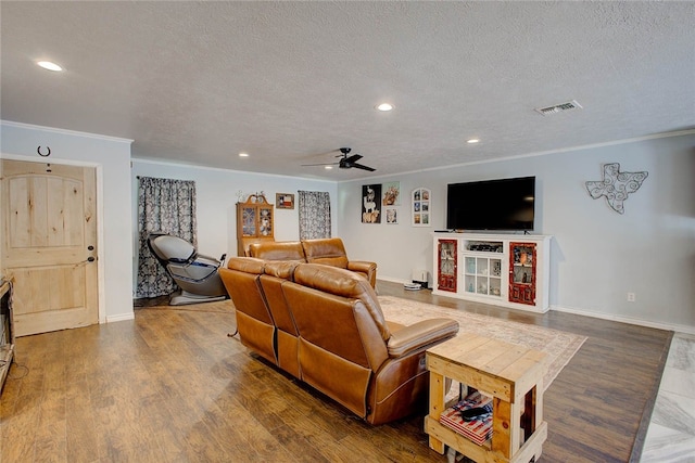 living room featuring ceiling fan, crown molding, wood-type flooring, and a textured ceiling