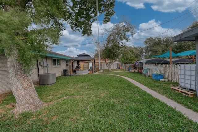 view of yard featuring a gazebo and central AC