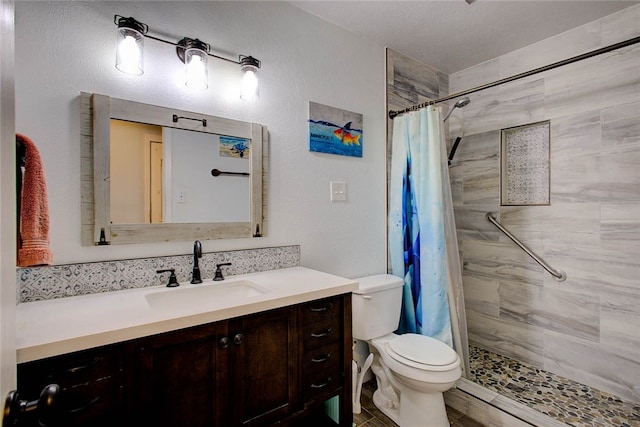 bathroom featuring toilet, vanity, and a shower with shower curtain