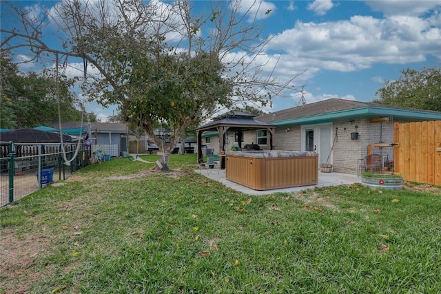 view of yard featuring a gazebo and a hot tub