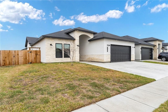 view of front of house featuring a front yard and a garage