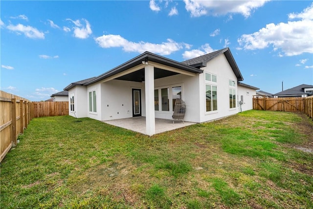 back of property featuring a lawn and a patio