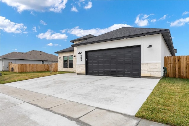 prairie-style home with a front lawn and a garage