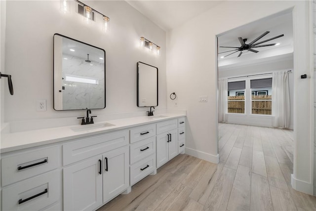 bathroom with ceiling fan, walk in shower, hardwood / wood-style floors, and vanity