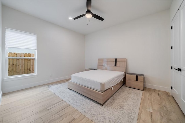 bedroom featuring ceiling fan and light hardwood / wood-style flooring