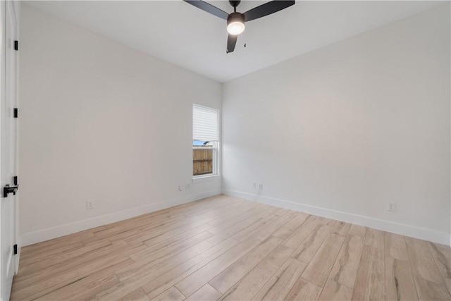 spare room with light wood-type flooring and ceiling fan